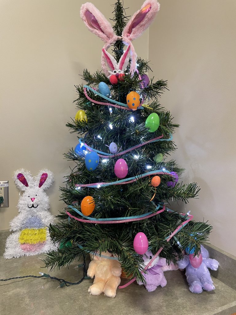 A Christmss tree decorated with Easter eggs and decor